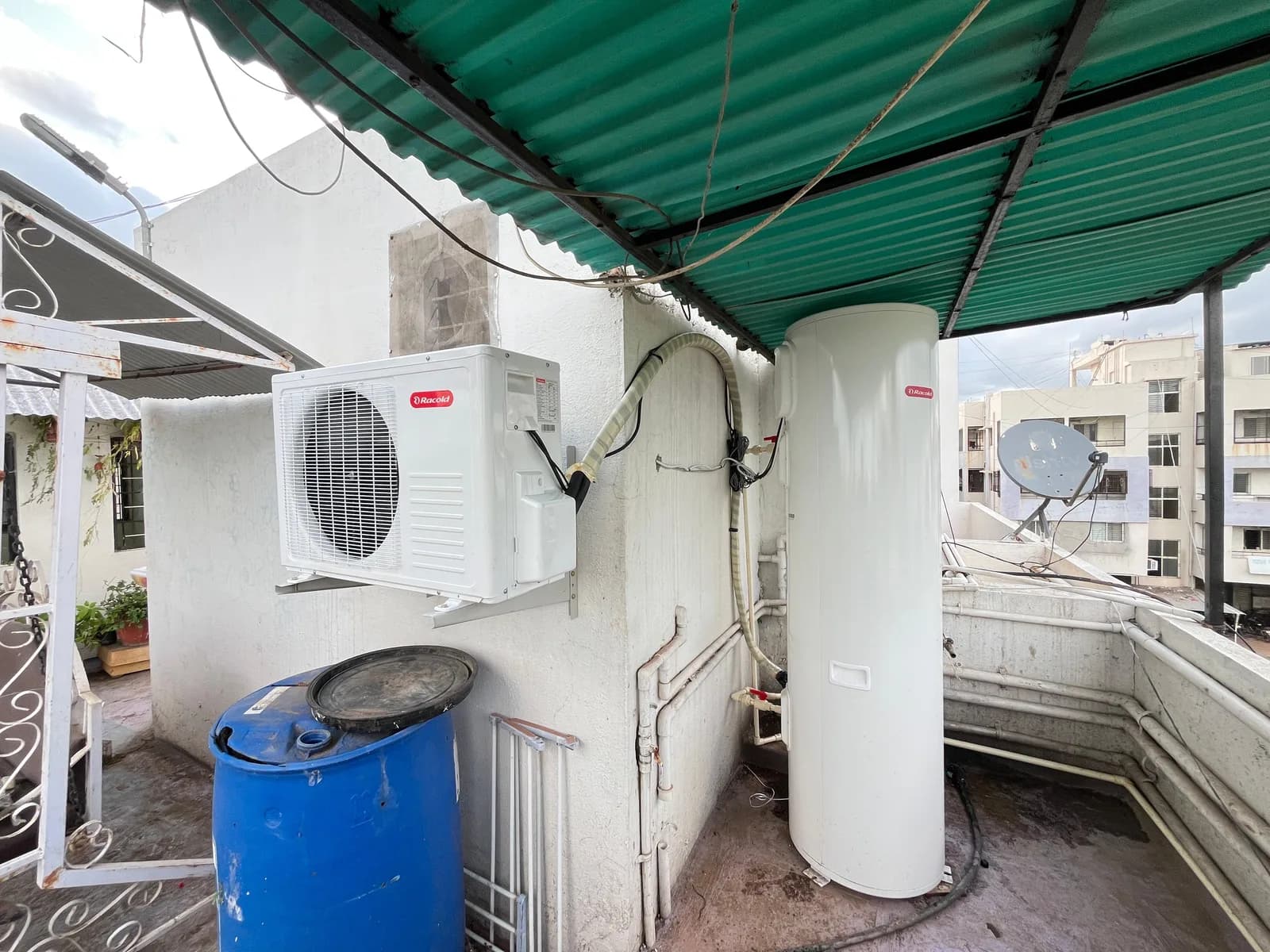 Racold domestic split heat pump installed with a vertical hot-water storage tank